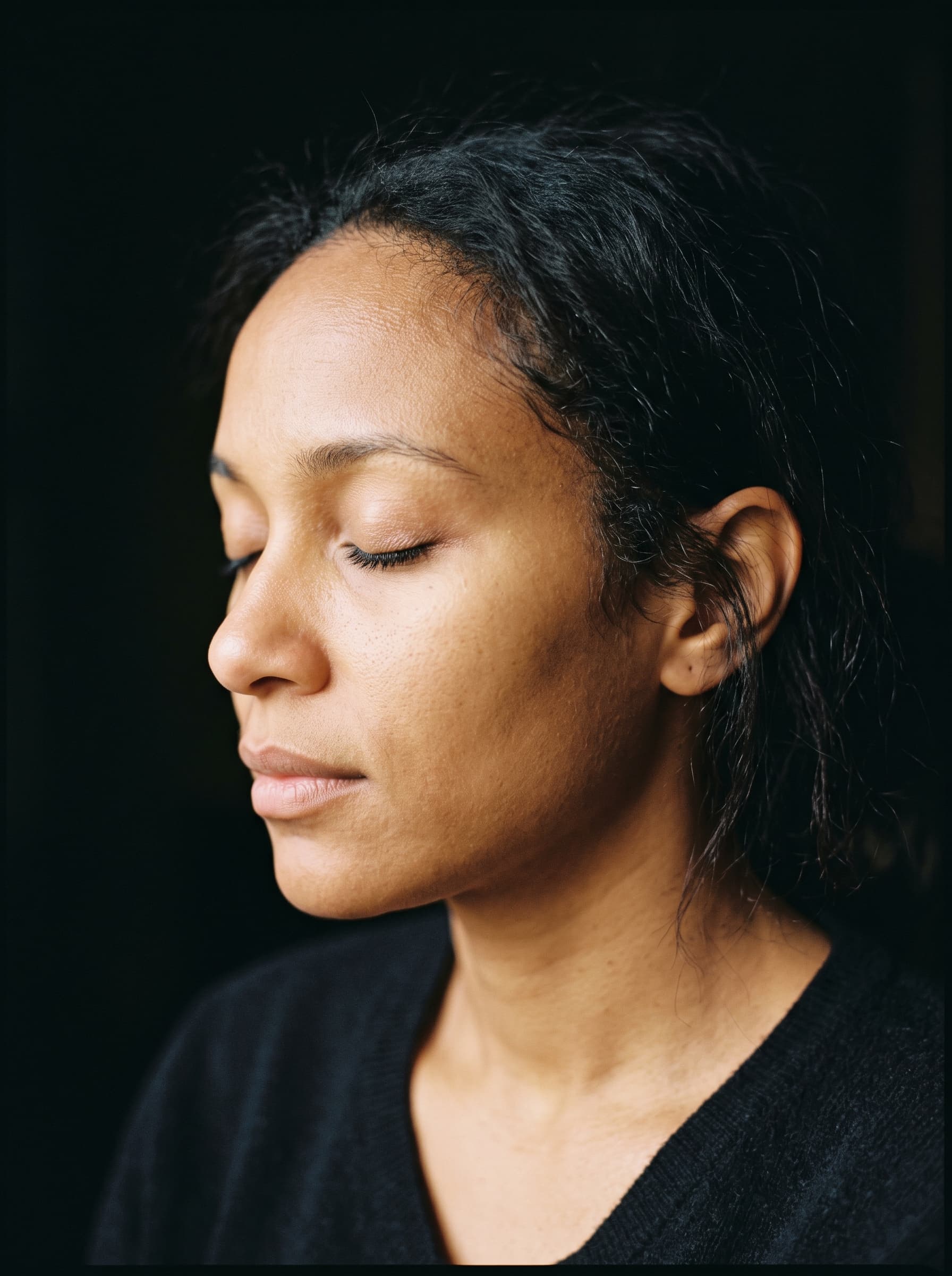 Person in quiet stillness, eyes closed